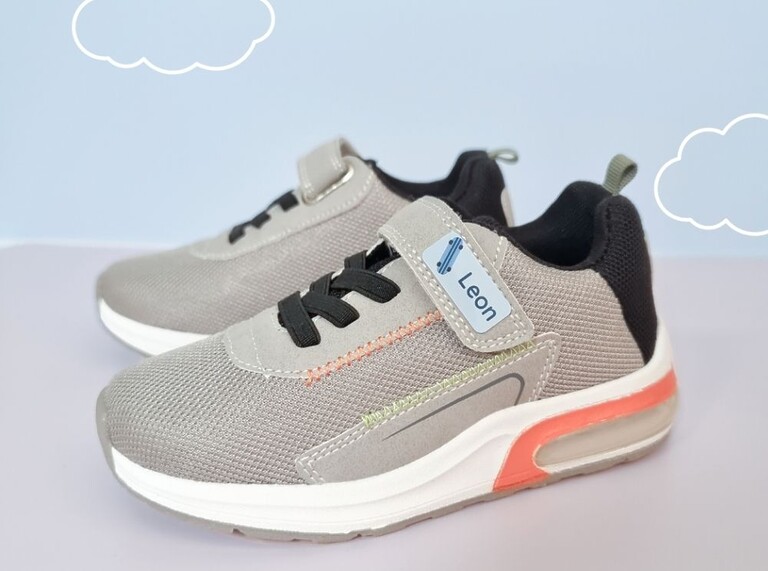 Gray sneakers with a personalized name label reading 'Leon'.
